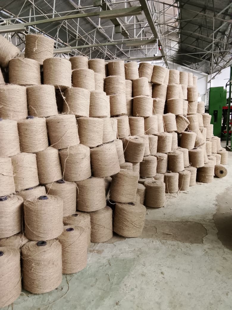 Jute yarn cops stacked high in the finished goods store, ready for despatch